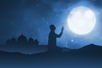 Silhouette of man pray to god on sand desert