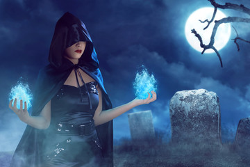 Asian beauty witch woman with blue fire on her hand