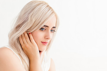 Beautiful blonde with tranquil look on her face. Young pensive woman with family issues thinking about something, copy space, white background