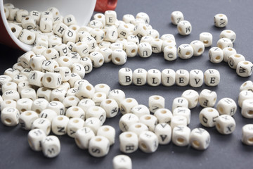 BELIEVE word written on wood block. Wooden ABC.