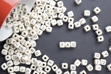 FAQ word written on wood block. Wooden ABC