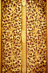 gold door of the temple is very beautiful pattern Lai Kanok (Thai design) carved wood.