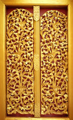 gold door of the temple is very beautiful pattern Lai Kanok (Thai design) carved wood.