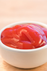 bowl of ketchup or tomato sauce on wooden table