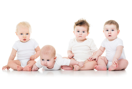 Group of cute  babies, crawling, over white. playing babies