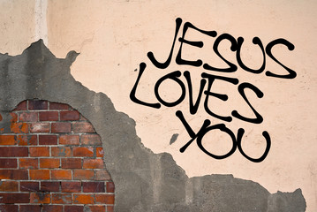 Jesus Loves You - handwritten graffiti sprayed on the wall, anarchist aesthetics - Christianity and Chist's unconditional love to everybody, including sinners and people with imperfections