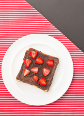 strawberry slice and hazelnut chocolate spread over a slice of b