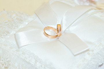 wedding rings on the white pillow