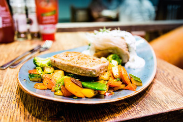 grilled salmon and lemon - french cuisine dish with tomato and s