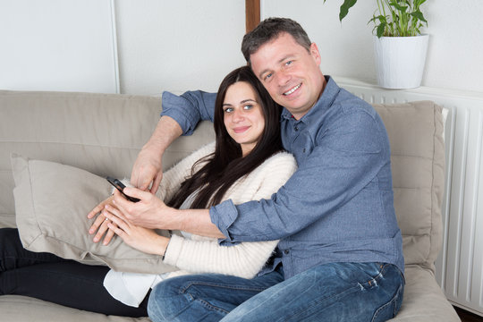 Romantic and lovely couple relaxing in couch