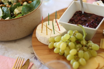 cheese platter with cherry preserves, grapes and brie