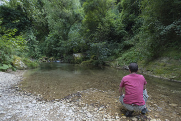 Obraz premium Man on the river, trekking, mountain