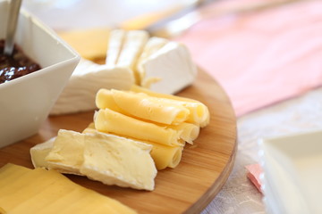 cheese platter with cherry preserves, grapes and various cheeses