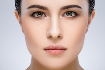 Darkhaired girl with nude make up at studio