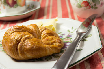 Croissant with Butter on a Plate