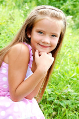 Portrait of adorable smiling little girl in summer day