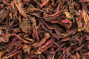 Organic dry Roselle (Hibiscus sabdariffa) leaves. Macro close up background texture. Top view.