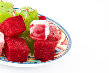 Sweet pieces of turkish delight on plate isolated and  white background

