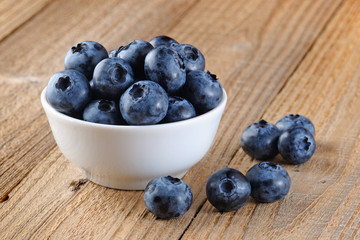 Blueberry in bowl on wooden table