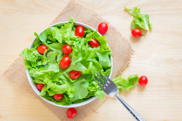 healthy food fresh vegetable salad and fork On a wooden table