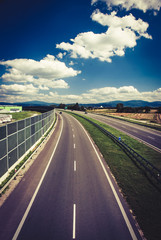 Highway against blue sky with clouds