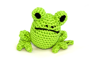 Knitted toy frog on white background