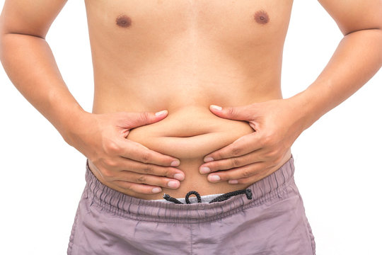 Closeup of man pinching belly fat, weight loss concept.