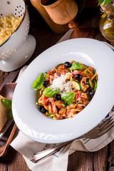 Ribbon Pasta with zucchini and olives in tomato sauce