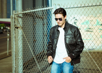 Male fashion model wearing leather jacket. 