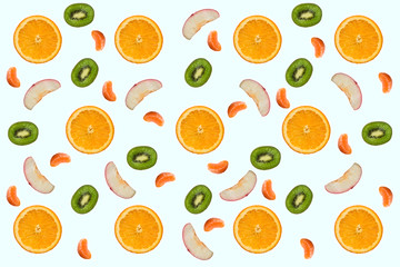 Parts of orange, kiwi, apple and tangerine on white background - natural fruit collage. Objects placed on a plane