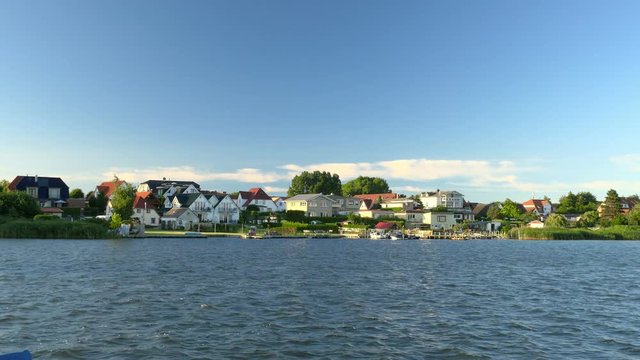 Beautiful lake scenery with houses in sunshine. Europe, Germany. Clip contains lake, water, building, coast	
