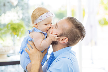 Dad embracing his baby girl
