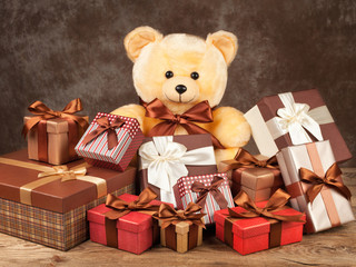 homemade teddy bear and a lot of boxes with gifts on the old boa