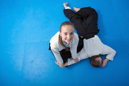 Two girls in black hakama training on Aikido training