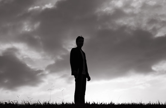 Man standing alone in a field. 
