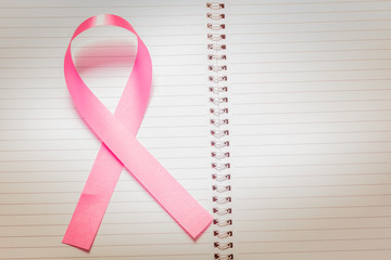  ribbon on notebook  with breast cancer awareness