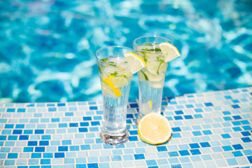 Mojito cocktail with lime and mint in highball glass on tre beach background Copy space