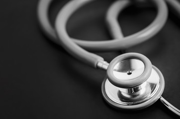 Close up of stethoscope on black table background
