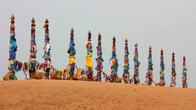Serge. Sacred poles with colored ribbons in island Olkhon. Burkhan, Lake Baikal