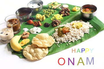 Onam feast on banana leaf isolated on white