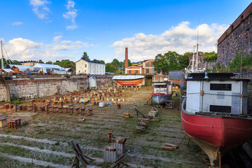 Fototapeta na wymiar Ship and boats in old dockyard on Suomenlinna in Finland.