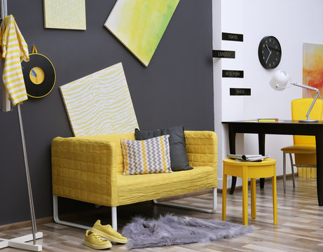 Stylish room interior with yellow couch