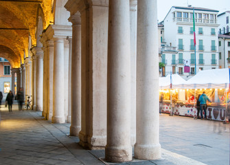 View of the columns and arches of the Palladian Basilica in Vicenza at dusk