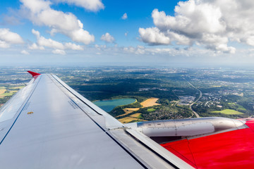 Earth and plane wing view over Helsinki, Finland.