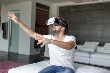 Man with virtual reality glass playing indoor