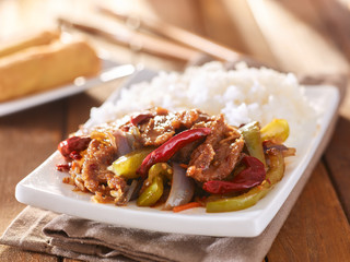 chinese szechuan beef with rice on plate