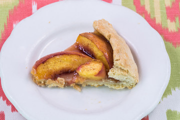 Piece of  homemade spiced peach galette.