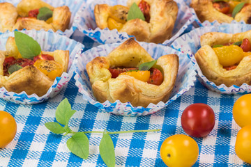 Fresh baked muffin pan tomato cheese tarts.