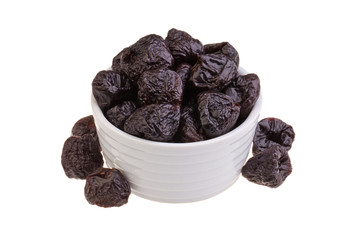 Dried prunes on white background