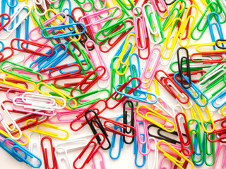 Pile of colorful paper clip on white background